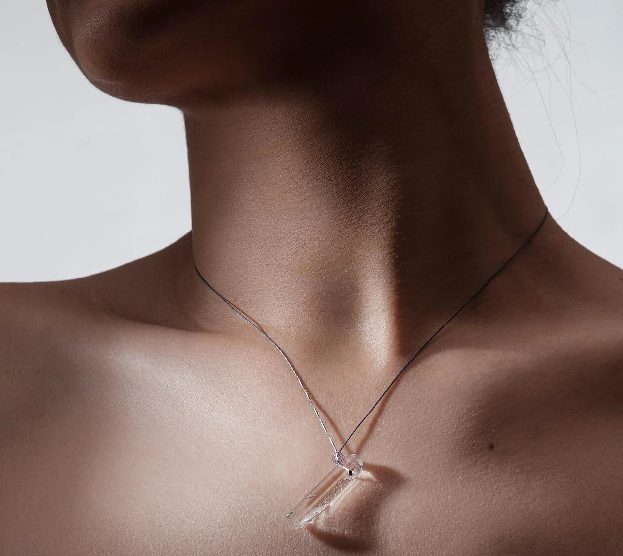 Handmade necklace featuring crystals in their most natural form - a choice of a single double terminated rock crystal or a nugget of purple amethyst, green amethyst or aquamarine - on a thin ("invisible") satin string. Silver clasp. — slika 2
