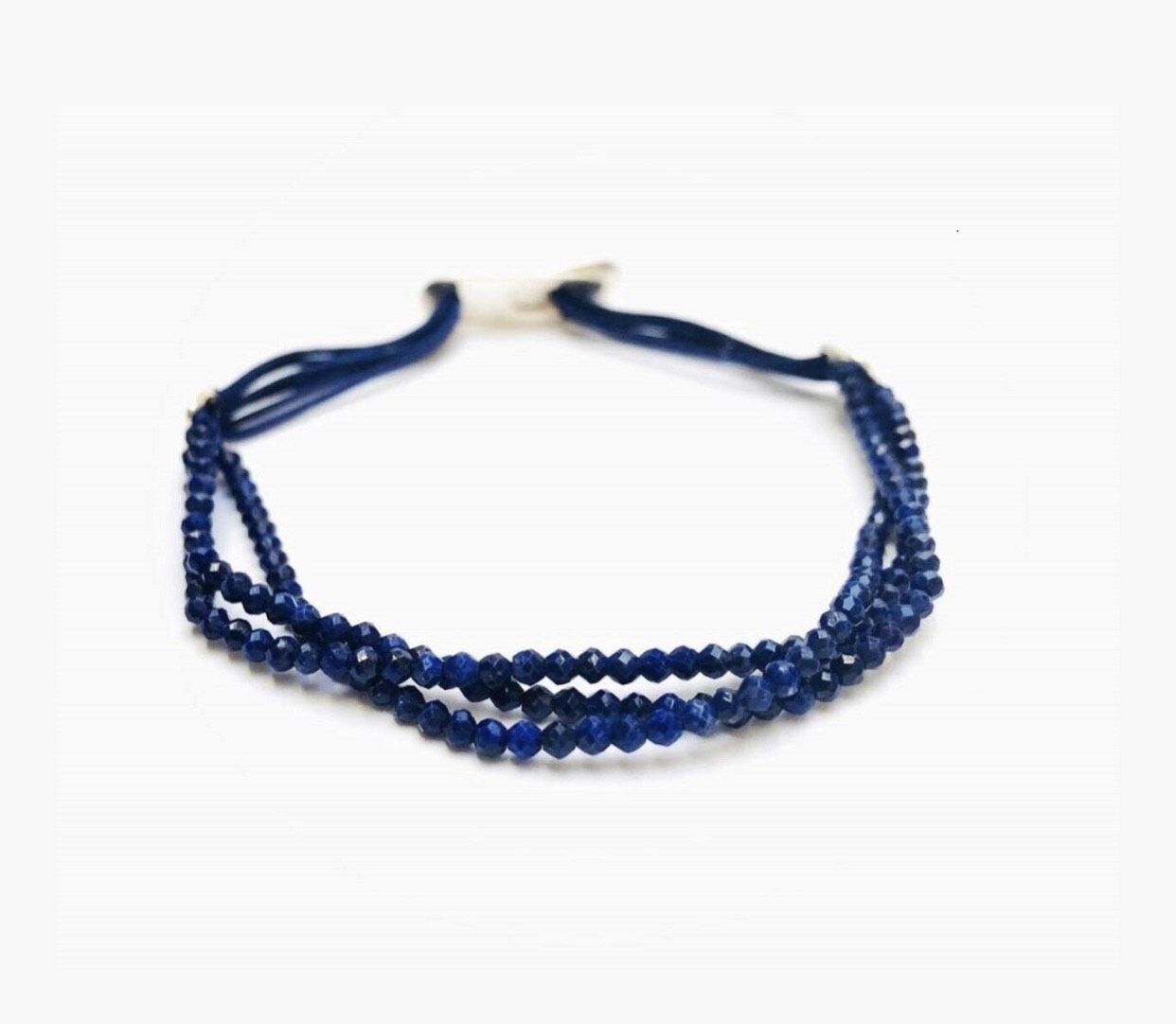 Handmade bracelet set with three lines of high quality faceted lapis lazuli beads strung on a quality satin string. Amaranthine signature handmade silver clasp.
