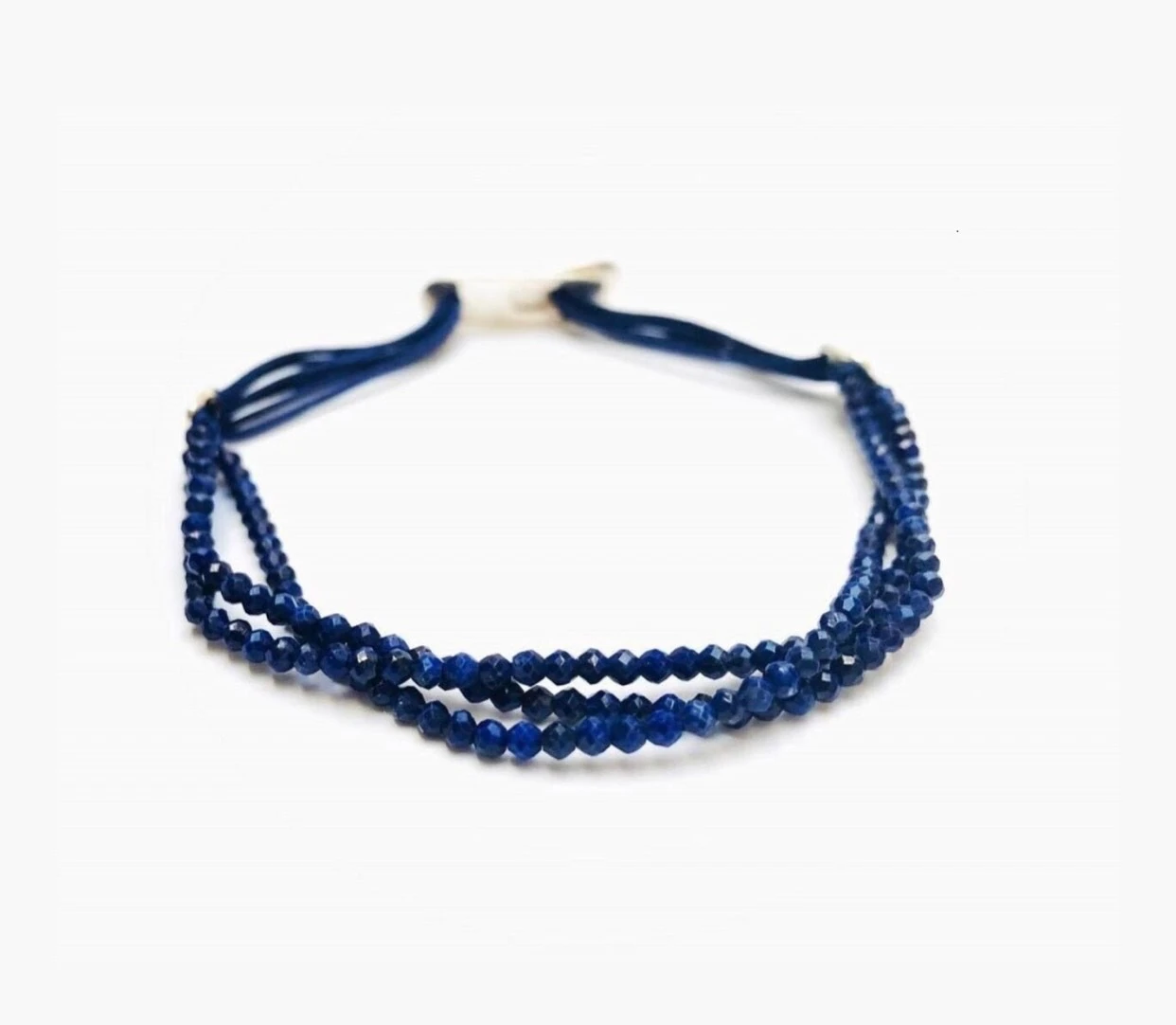 Handmade bracelet set with three lines of high quality faceted lapis lazuli beads strung on a quality satin string. Amaranthine signature handmade silver clasp.