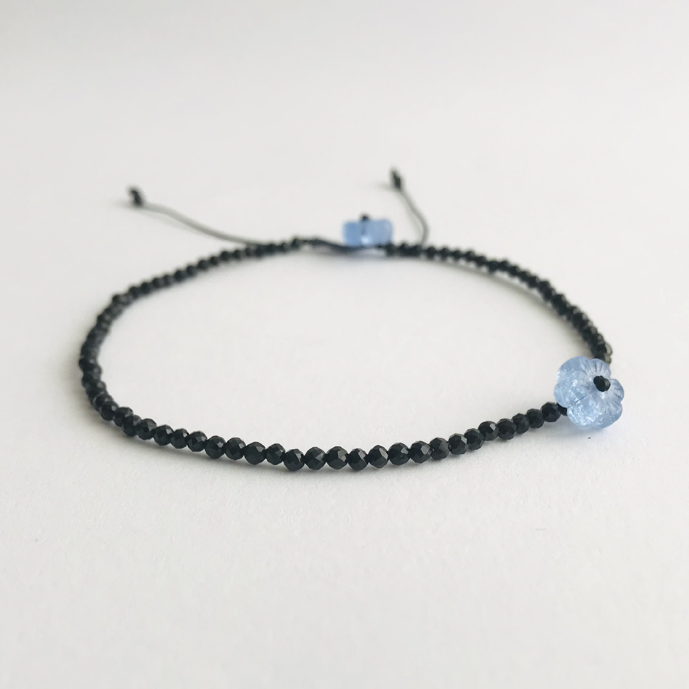 Handmade bracelet set with faceted gemstone beads - black spinel, African turquoise, mooonstone, lapis lazuli or a mix of them all (multigem) - strung on a quality satin string. Accented with a flower in different color. Adjustable length.