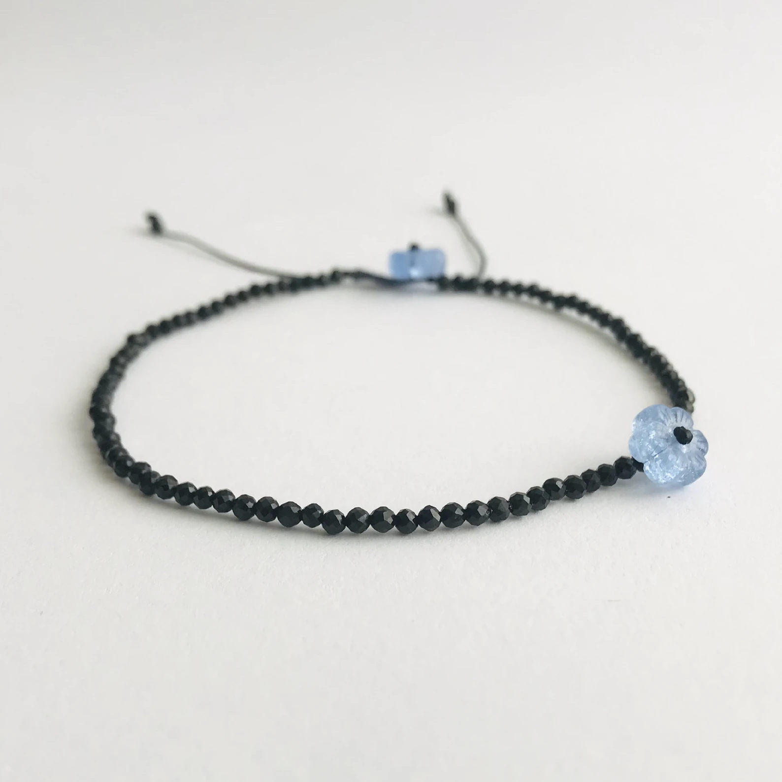 Handmade bracelet set with faceted gemstone beads - black spinel, African turquoise, mooonstone, lapis lazuli or a mix of them all (multigem) - strung on a quality satin string. Accented with a flower in different color. Adjustable length.